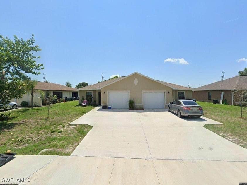 a front view of a house with a yard and garage