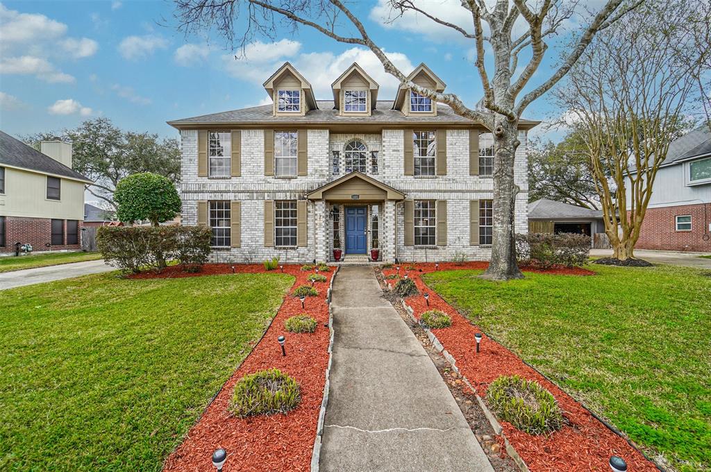 a front view of house with yard and green space