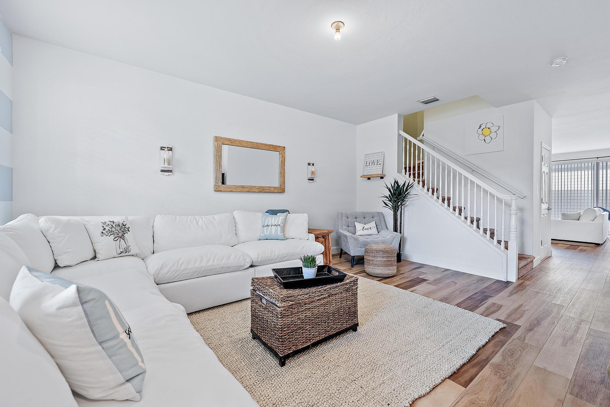 a living room with furniture and wooden floor