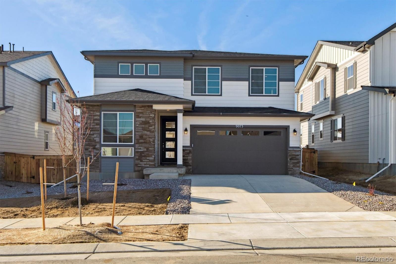 a front view of a house with garage and kitchen