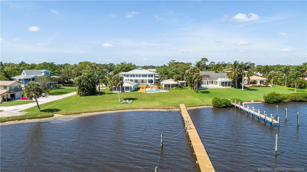 a view of a house with a yard and lake view