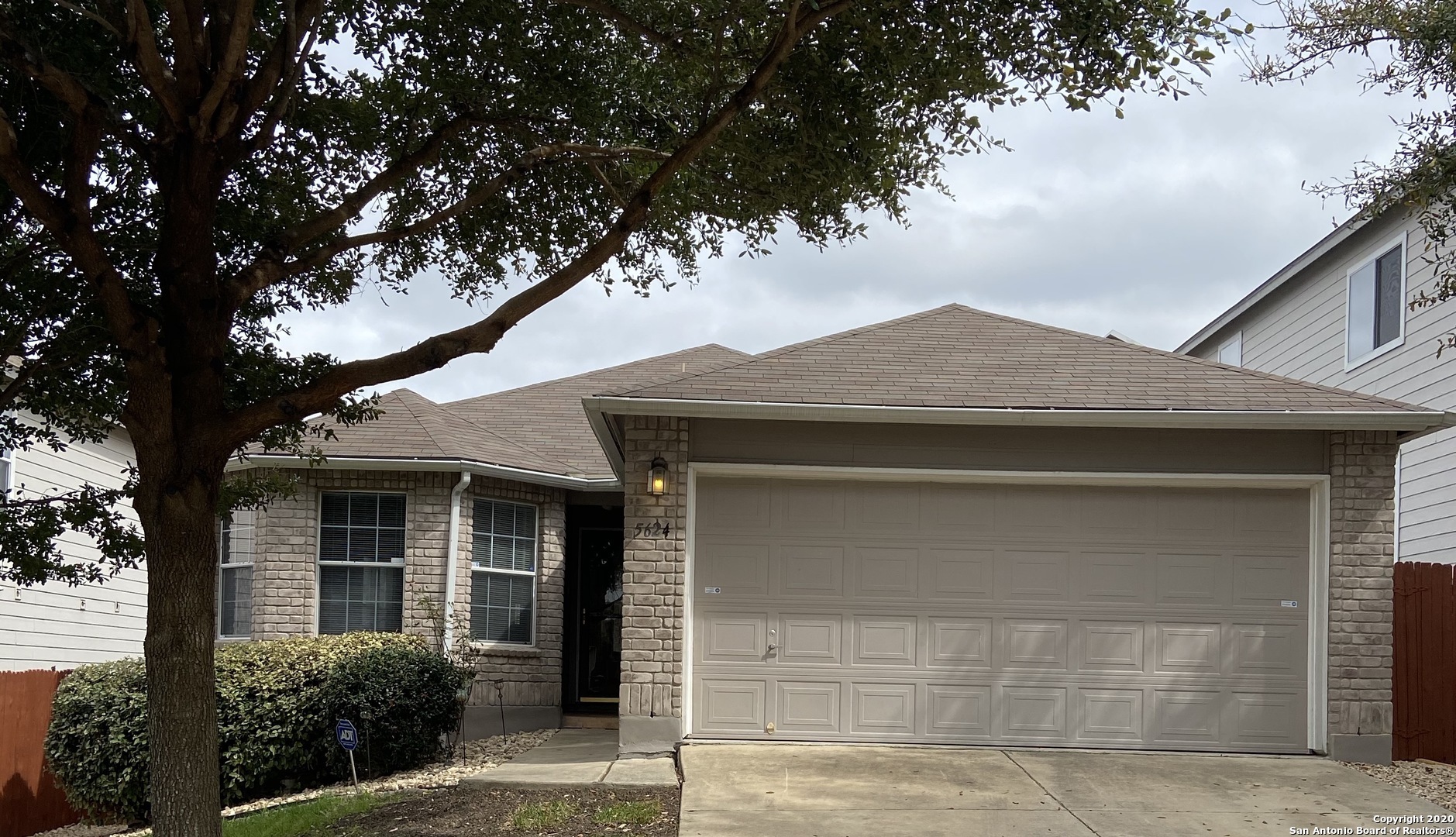 front view of a house with a tree