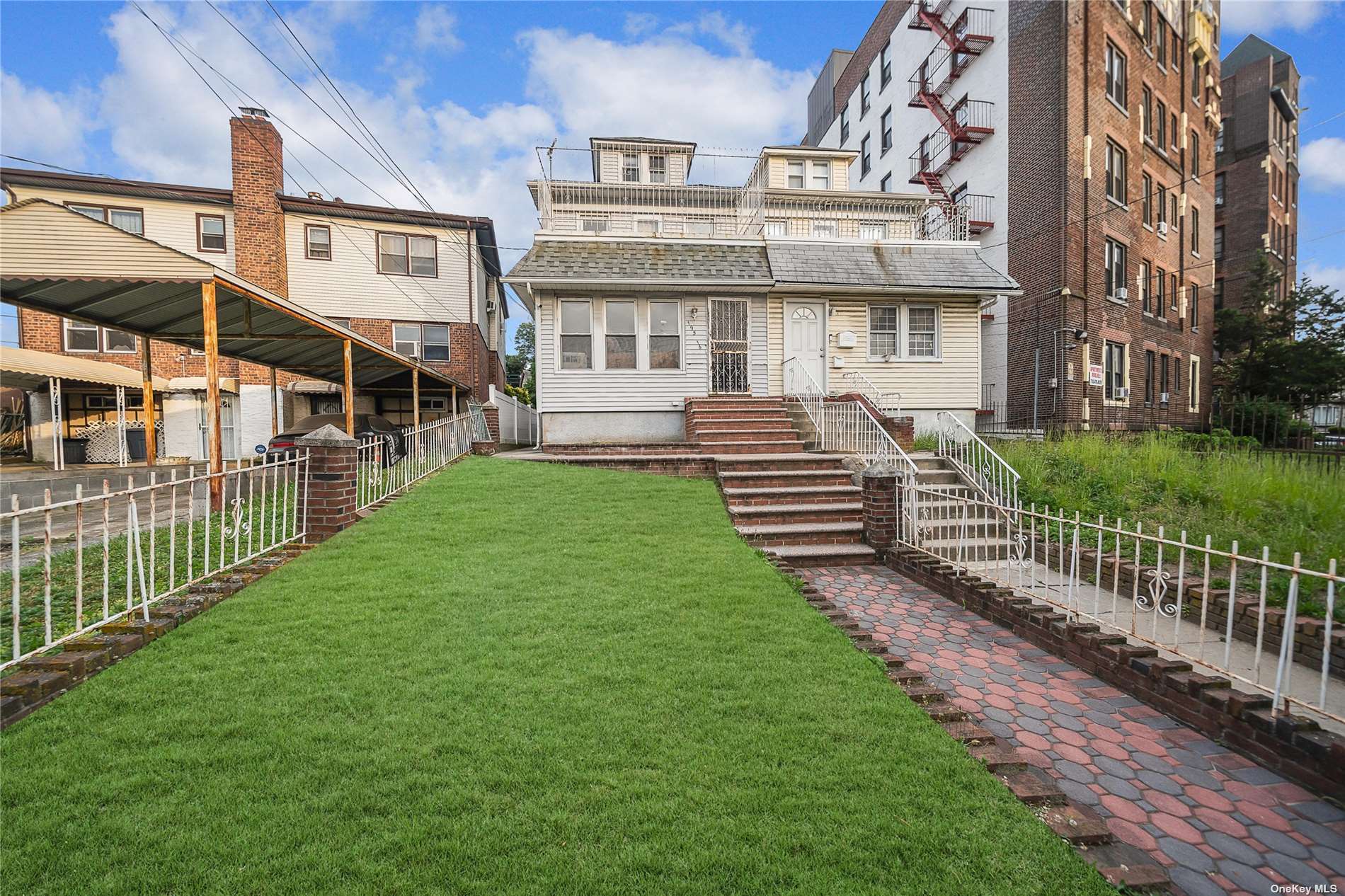 a view of a brick house with a yard and a large tree