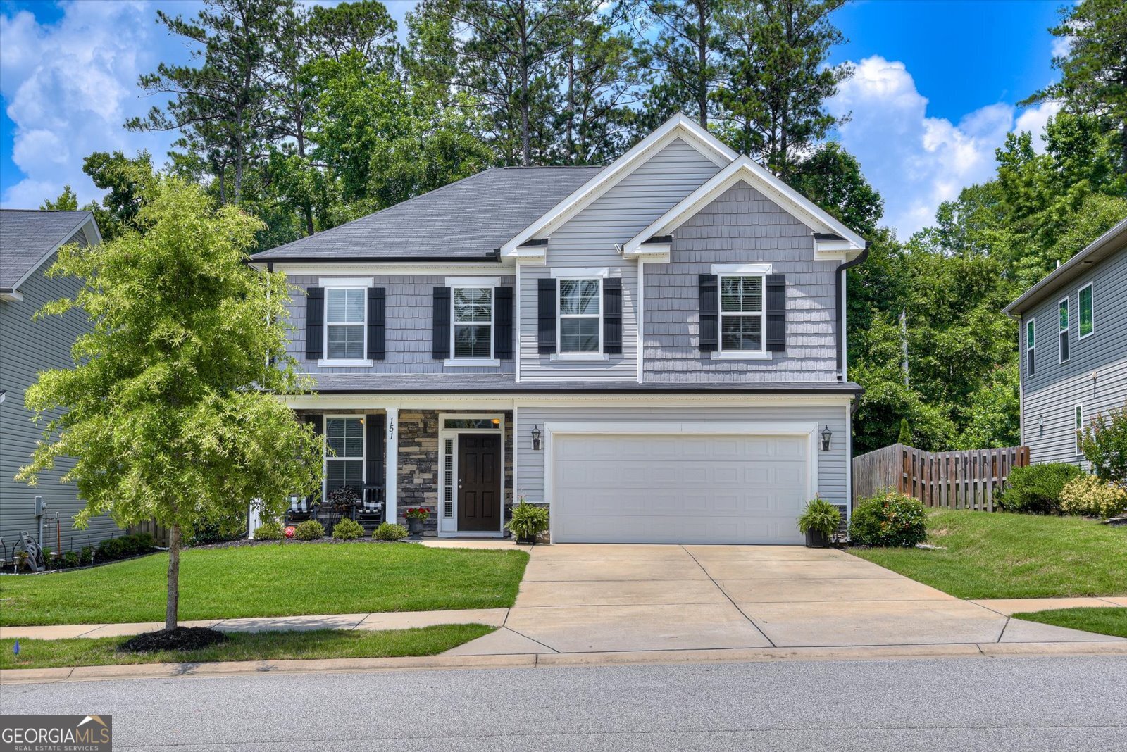 a front view of a house with a garden