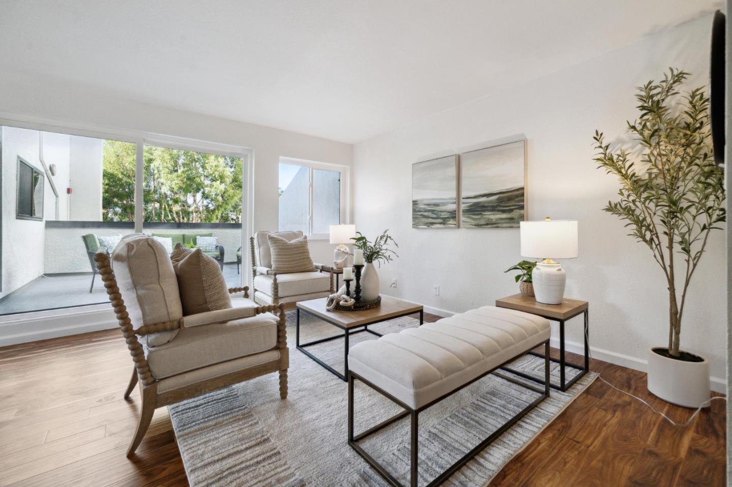 a living room with furniture and a potted plant