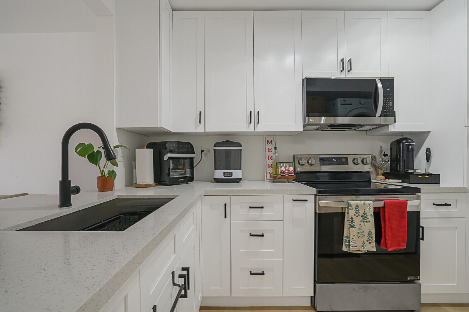 a kitchen with stainless steel appliances granite countertop a stove and a white cabinets