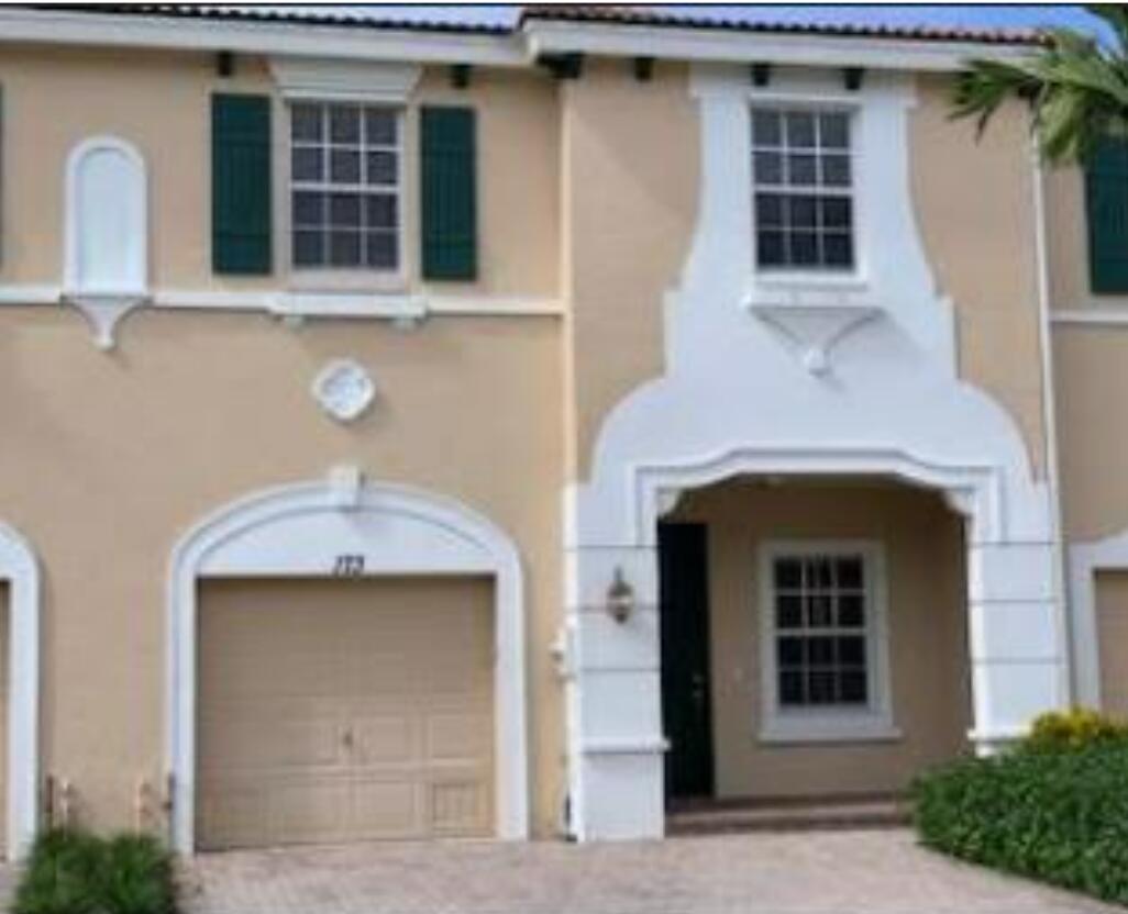 a front view of a house with large windows