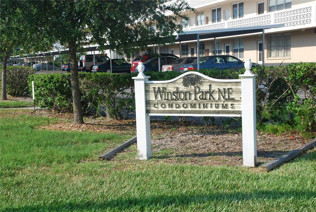 a view of street sign of a house on a green field