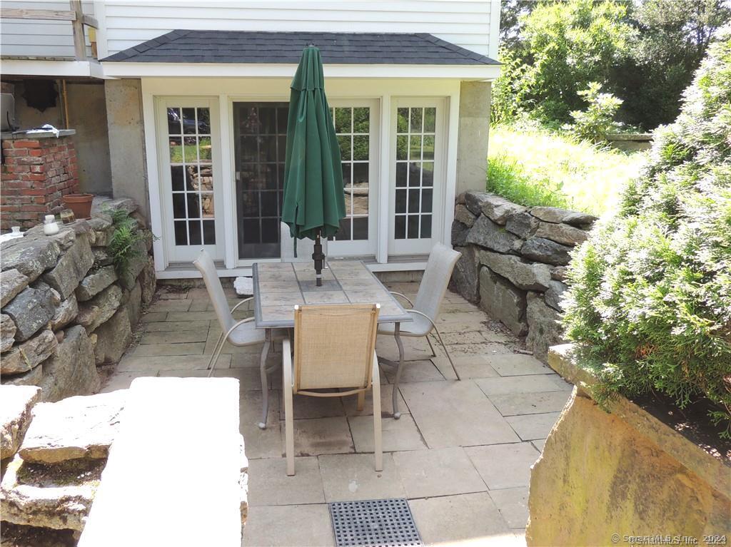 a view of a patio with table and chairs and potted plants