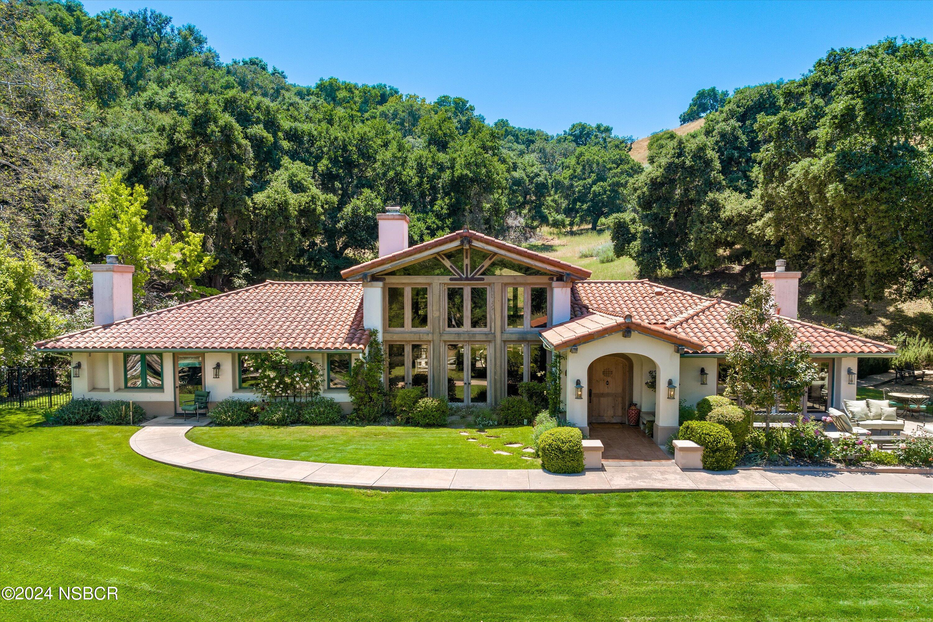 a view of house with garden space and trees