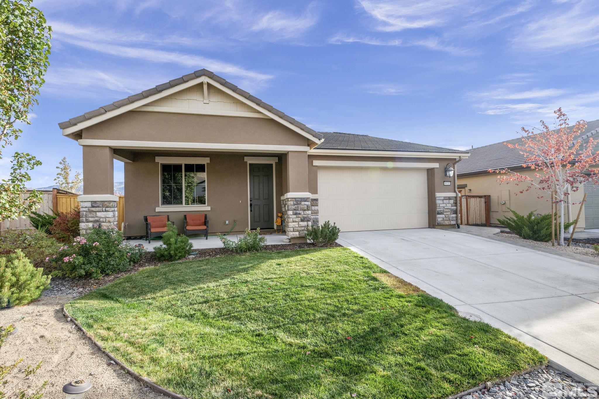 a front view of a house with a yard and garage