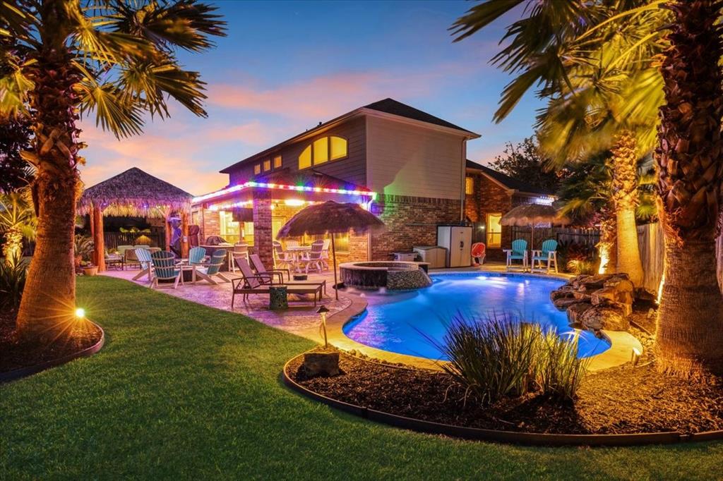 a view of a house with swimming pool yard and sitting area