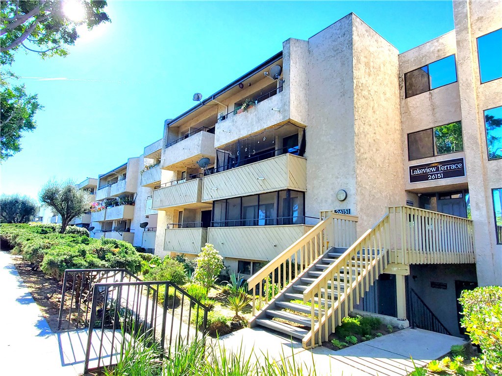 a view of balcony with staircase and outdoor seating