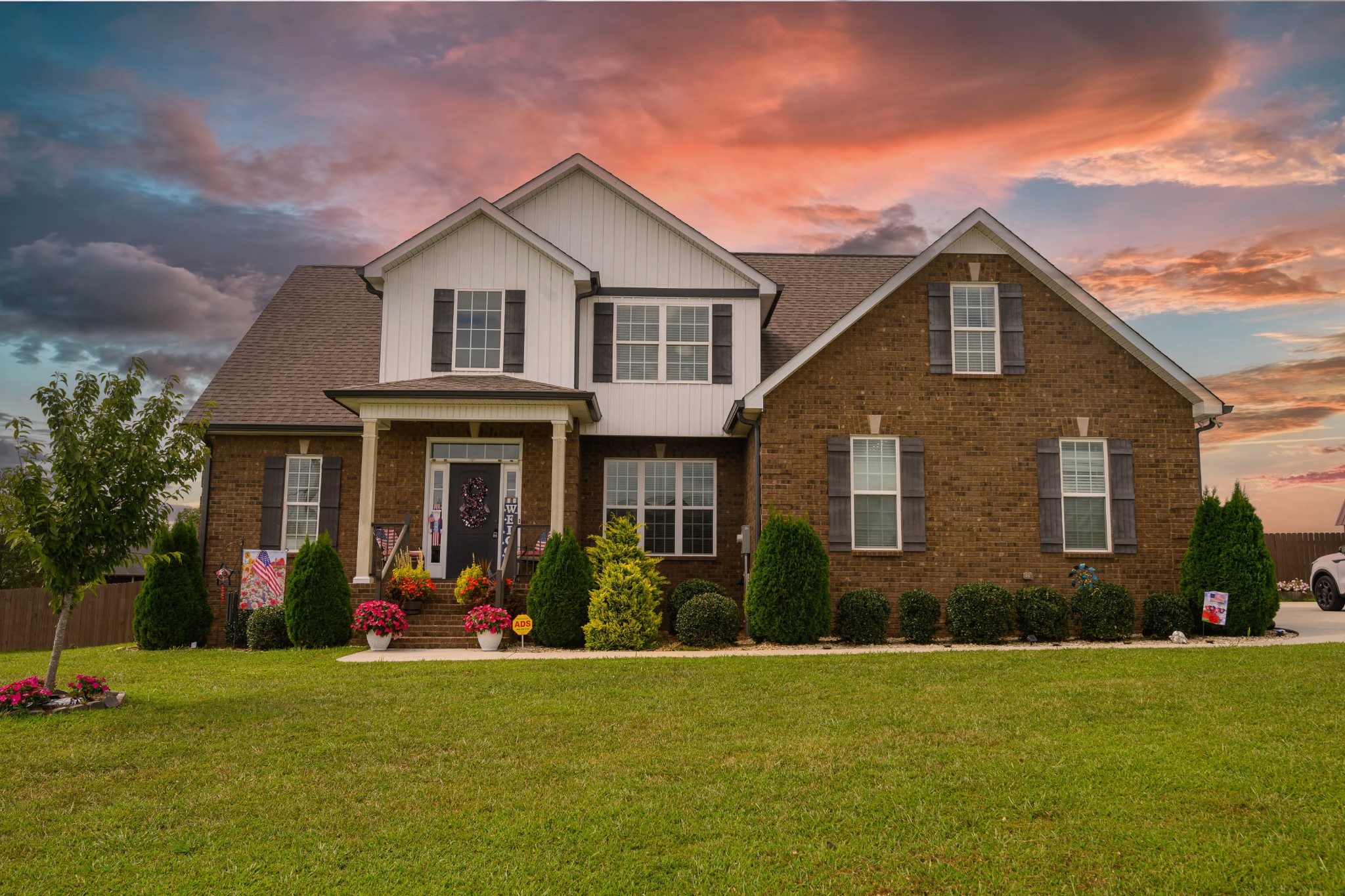 a front view of a house with a yard and garage