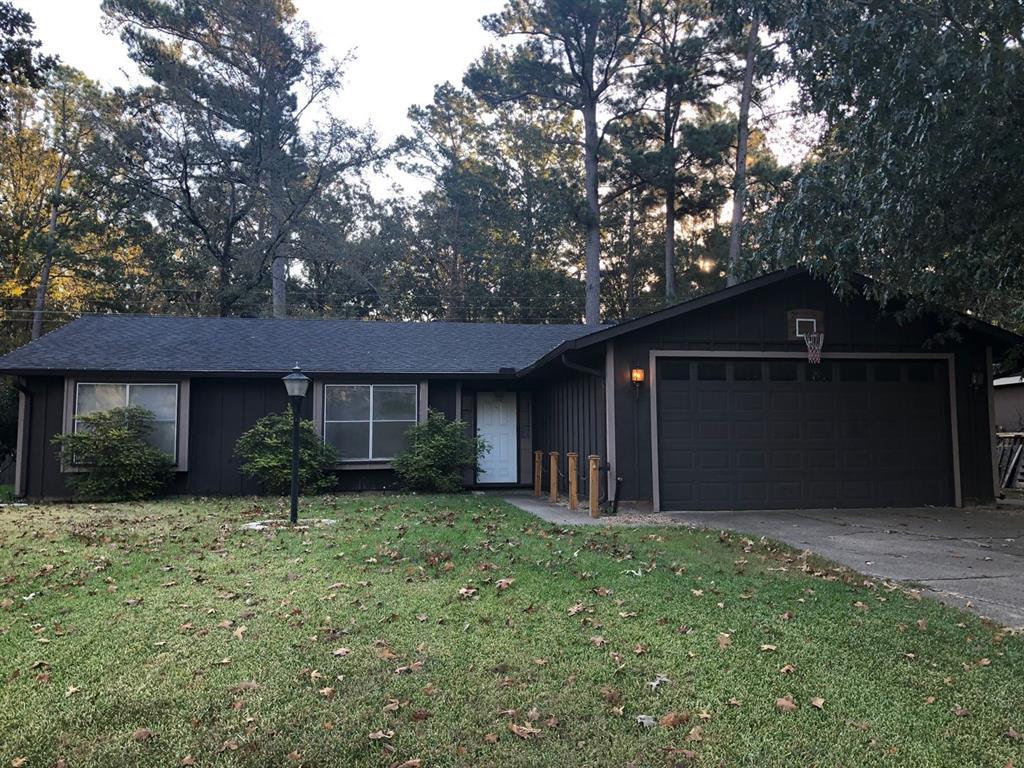 a front view of a house with yard and green space