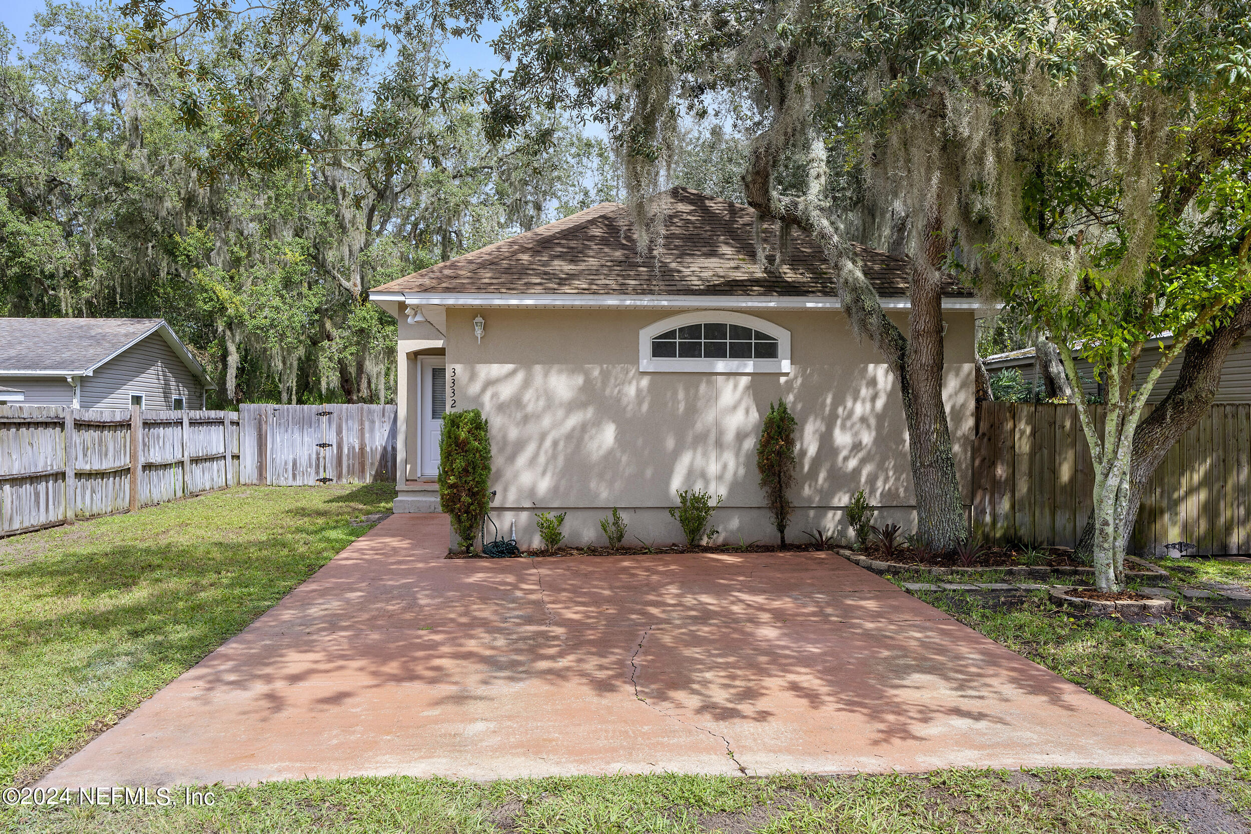 a front view of house with yard and trees