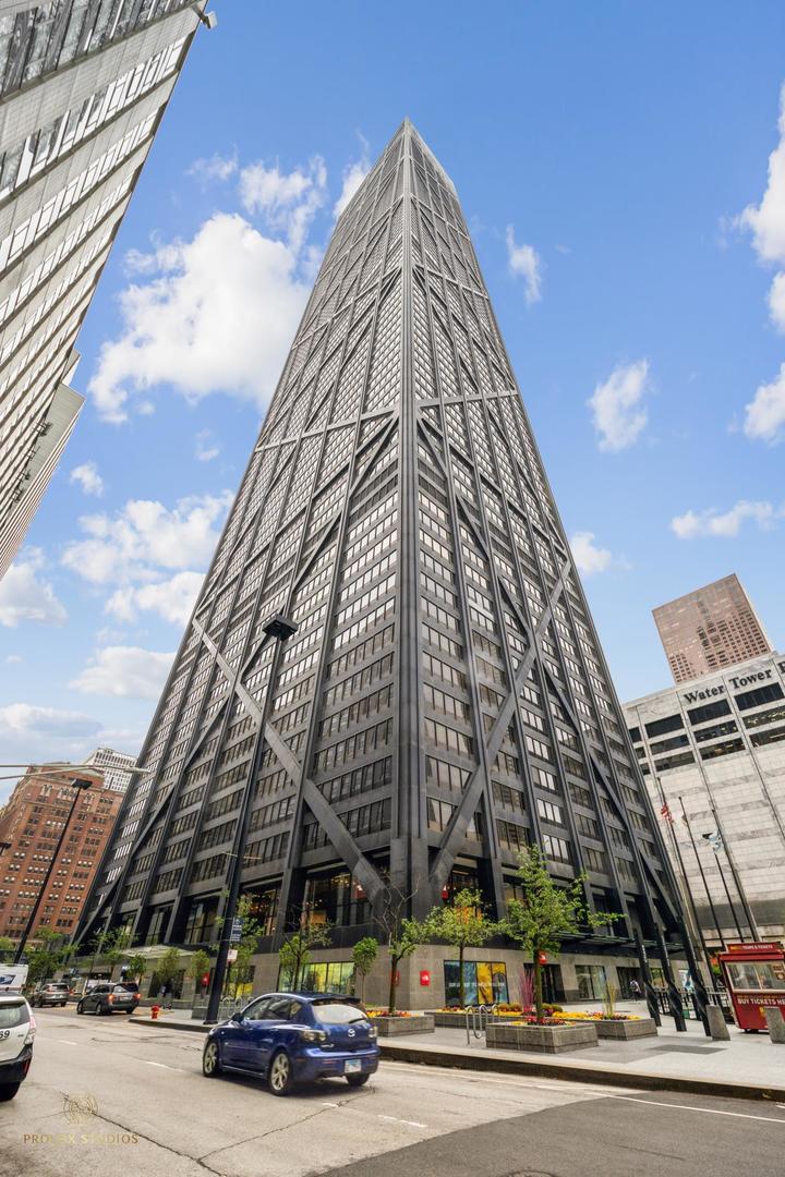 a view of a tall building next to a road