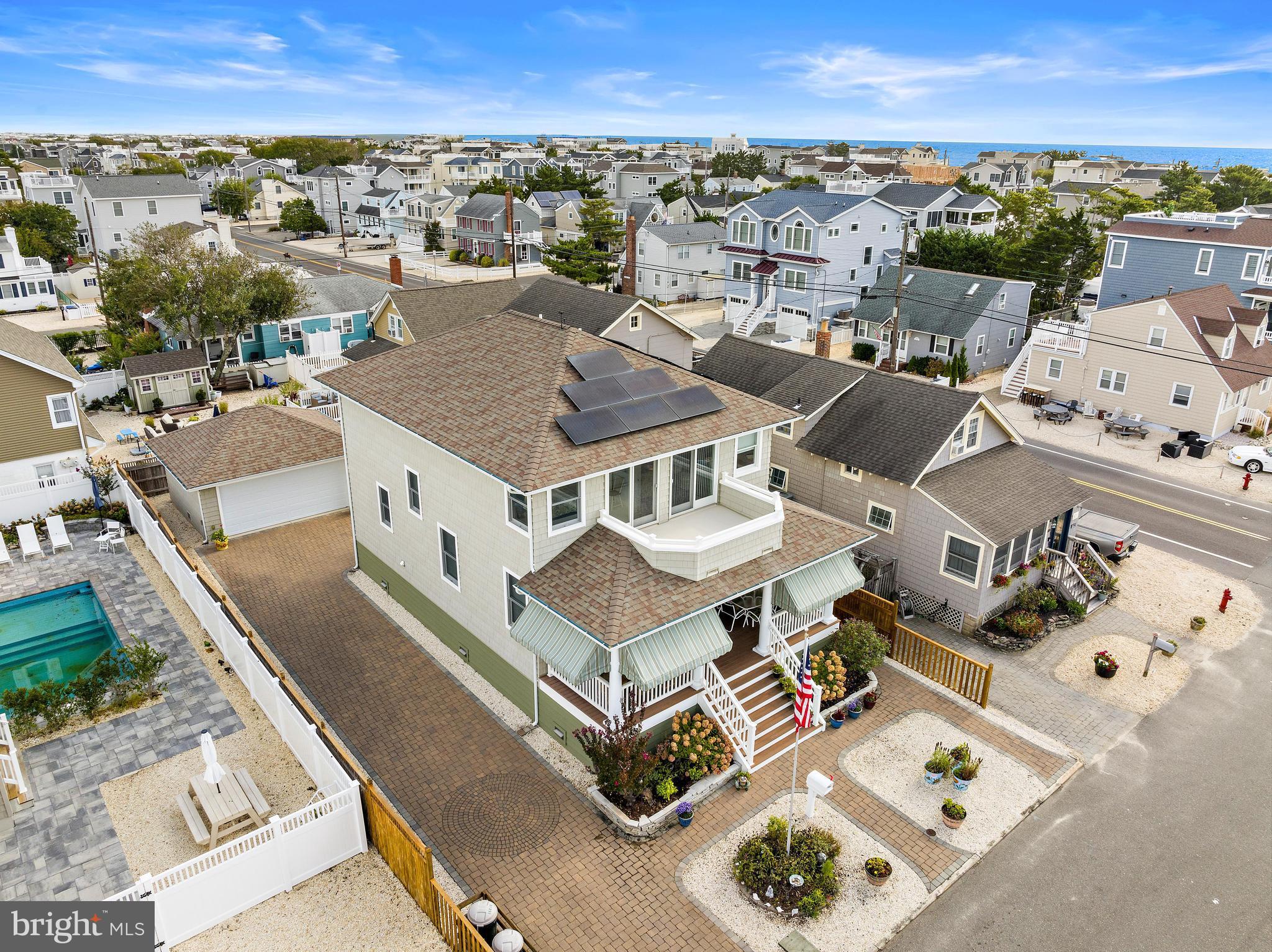 an aerial view of a houses with a city view