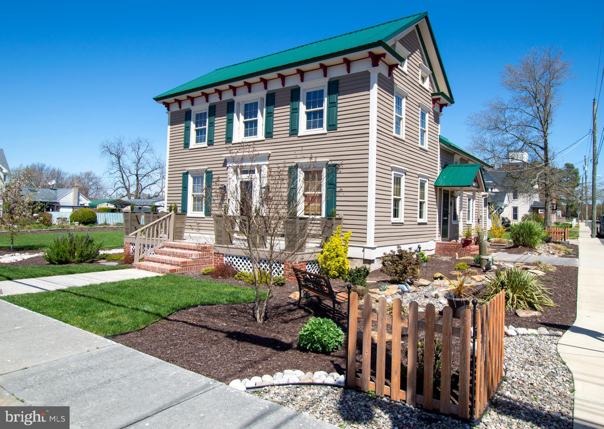 a front view of house with a garden and patio