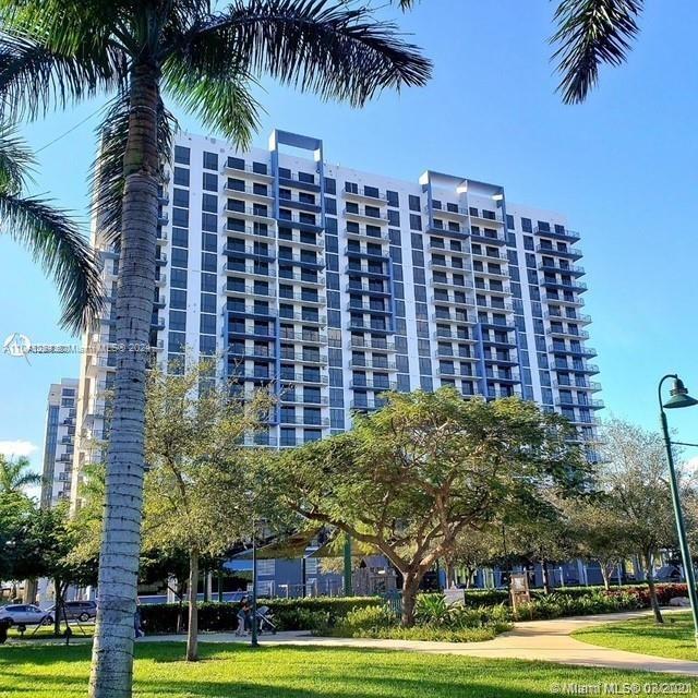 a view of a palm trees and a building in the background