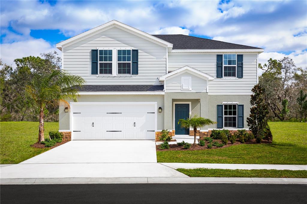 a front view of a house with a yard and garage