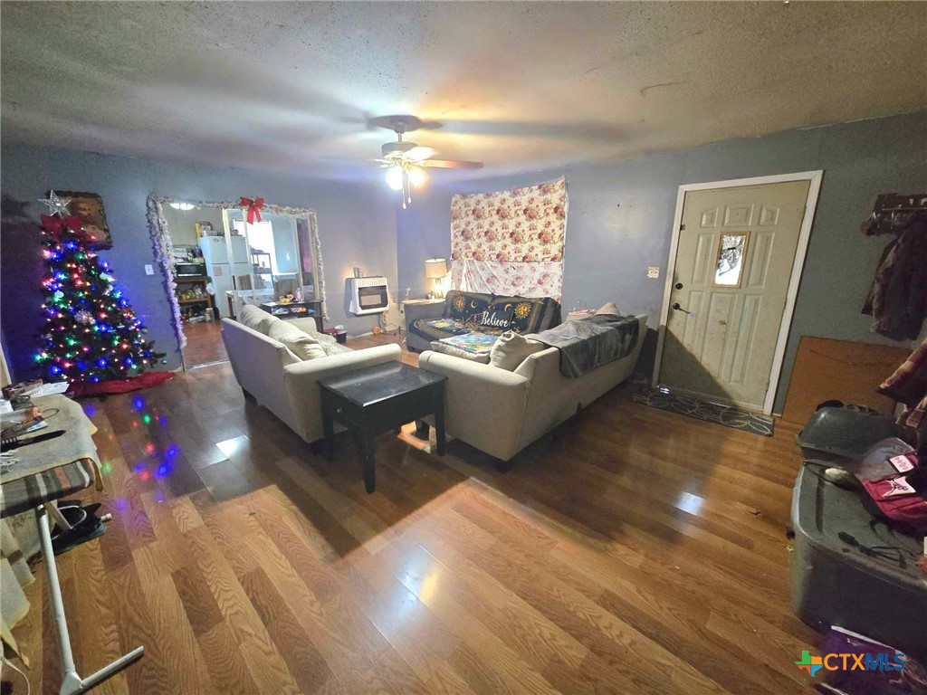 a living room with furniture gym equipment and a chandelier