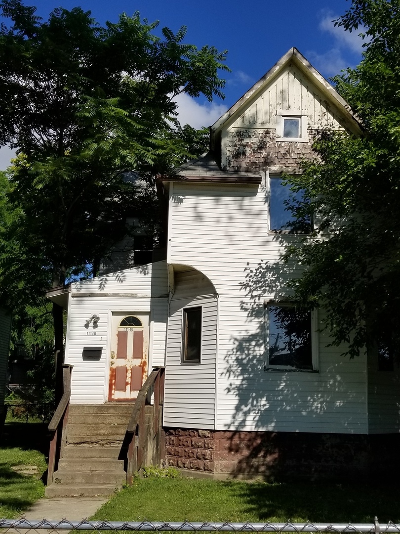 a view of a white house with a yard