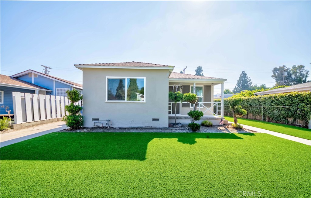 a view of a house with a backyard porch and sitting area