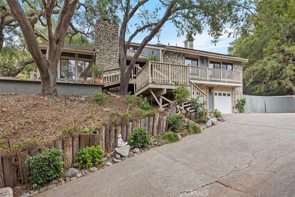 front view of a house with a tree