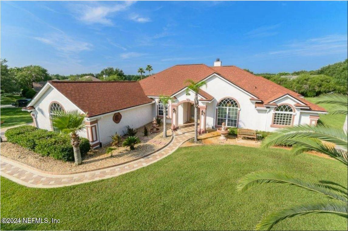 a view of a house with backyard porch and sitting area