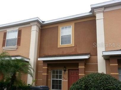 a front view of a house with plants