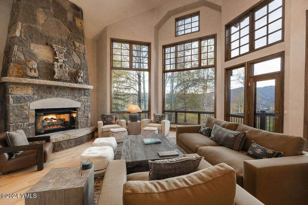 a living room with furniture fireplace and a large window