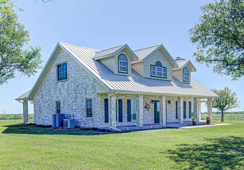 a front view of a house with a garden and porch