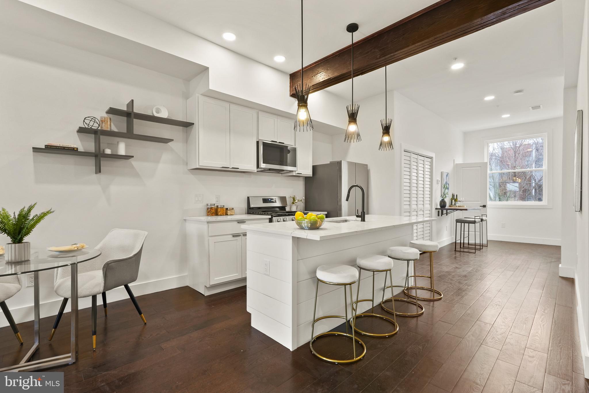 a kitchen with a sink cabinets and wooden floor