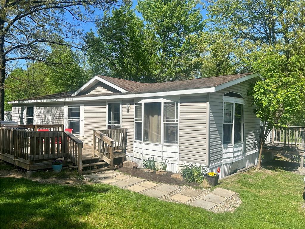 a view of a house with a yard chairs and a table