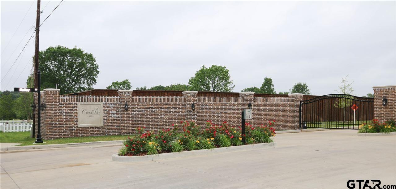 a view of a brick house next to a road and a building