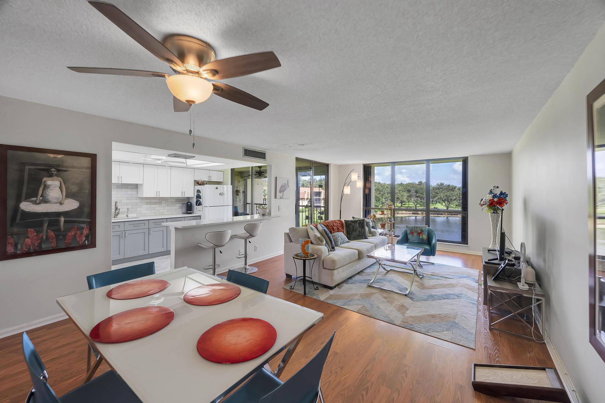 a living room with furniture a rug and a large window