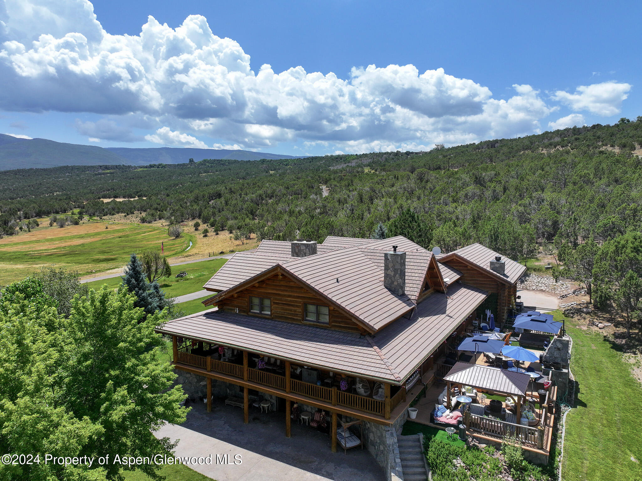 an aerial view of a house with big yard