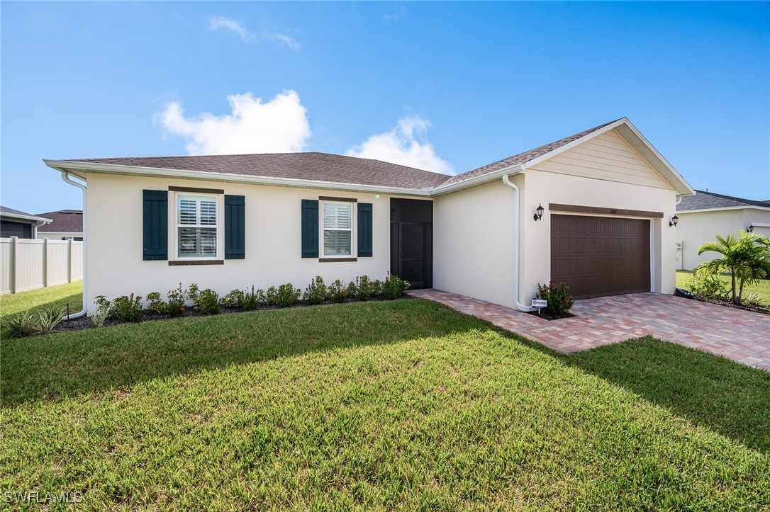 a front view of house with yard and green space