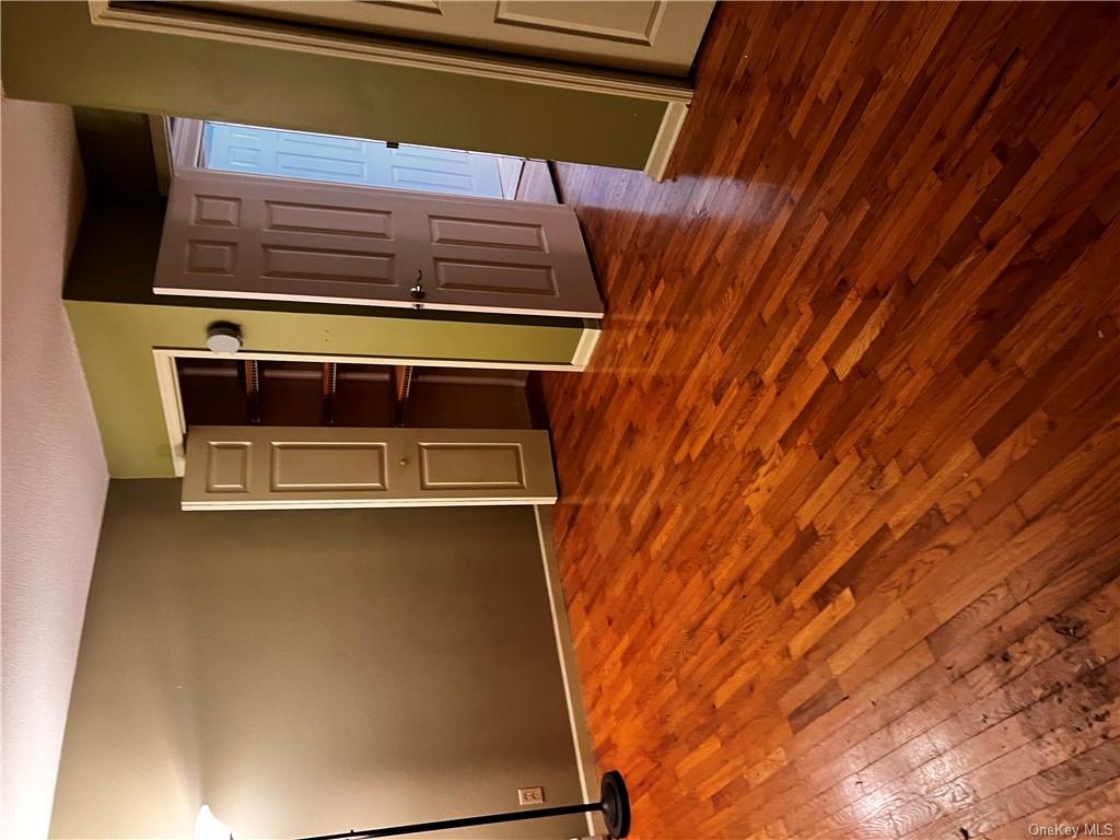 Unfurnished bedroom featuring dark wood-type flooring and a textured ceiling