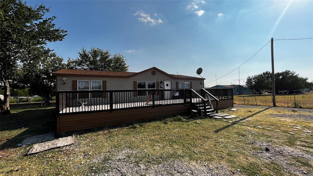 a view of house with a yard