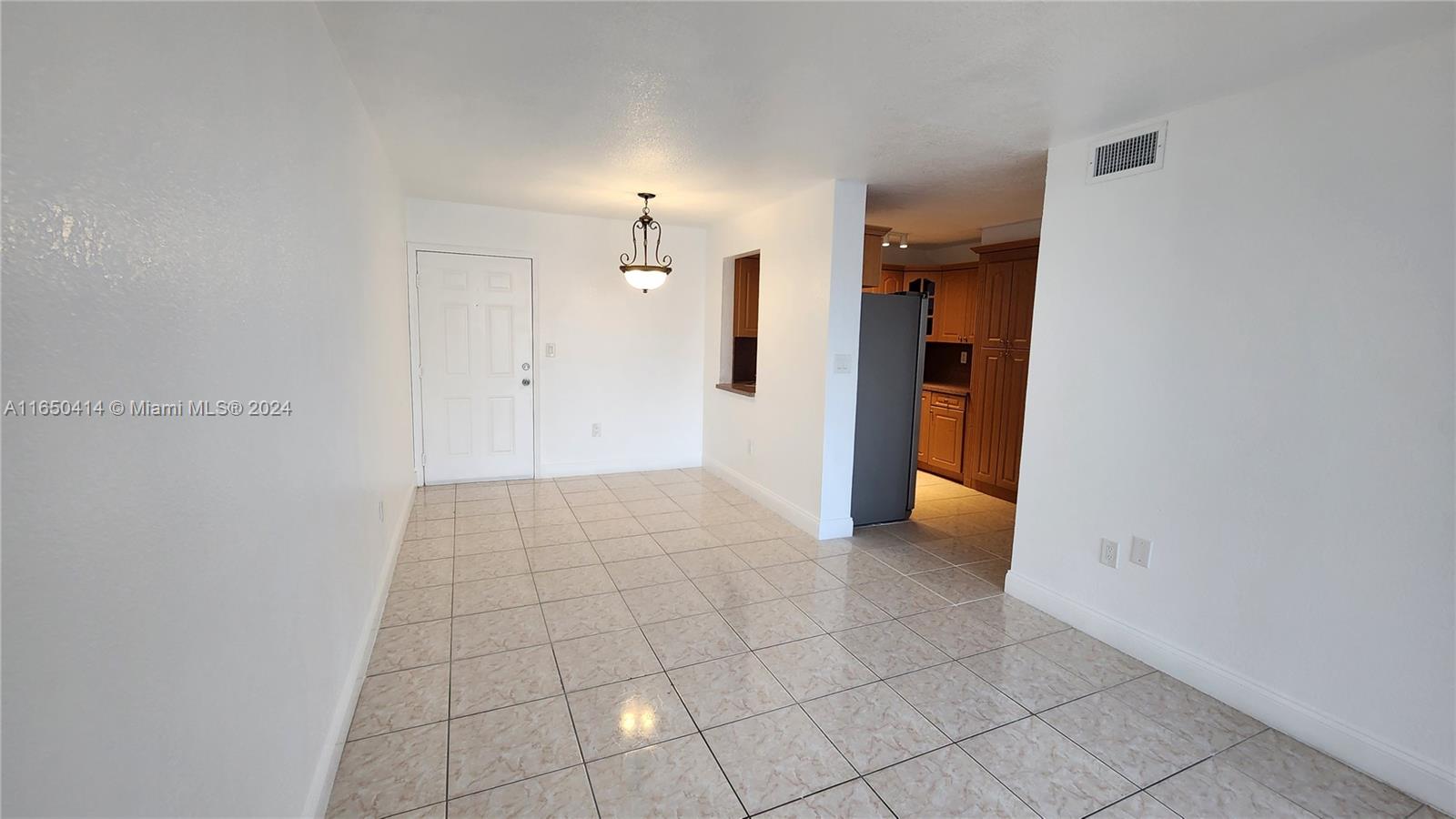 a view of a room with an empty space and a window