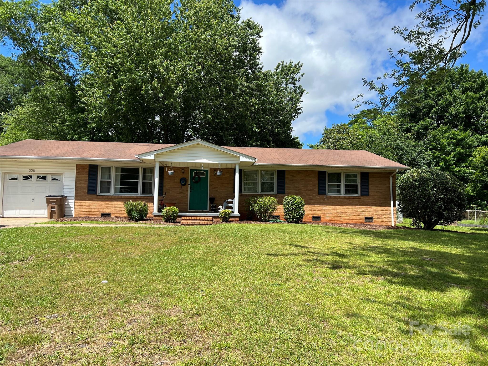 a front view of a house with swimming garden and porch