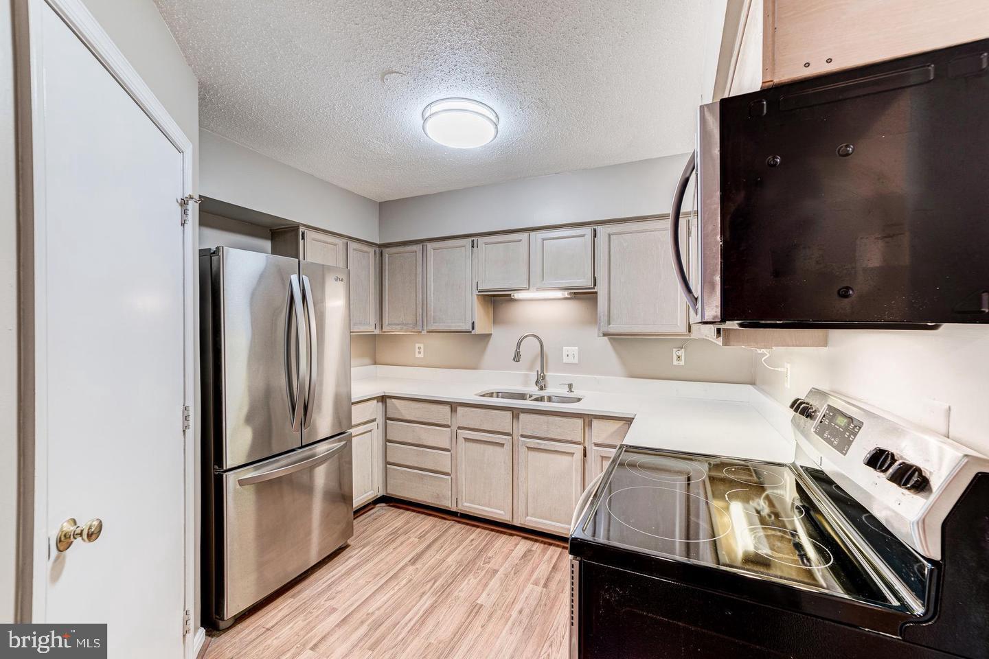 a kitchen with a sink appliances and cabinets