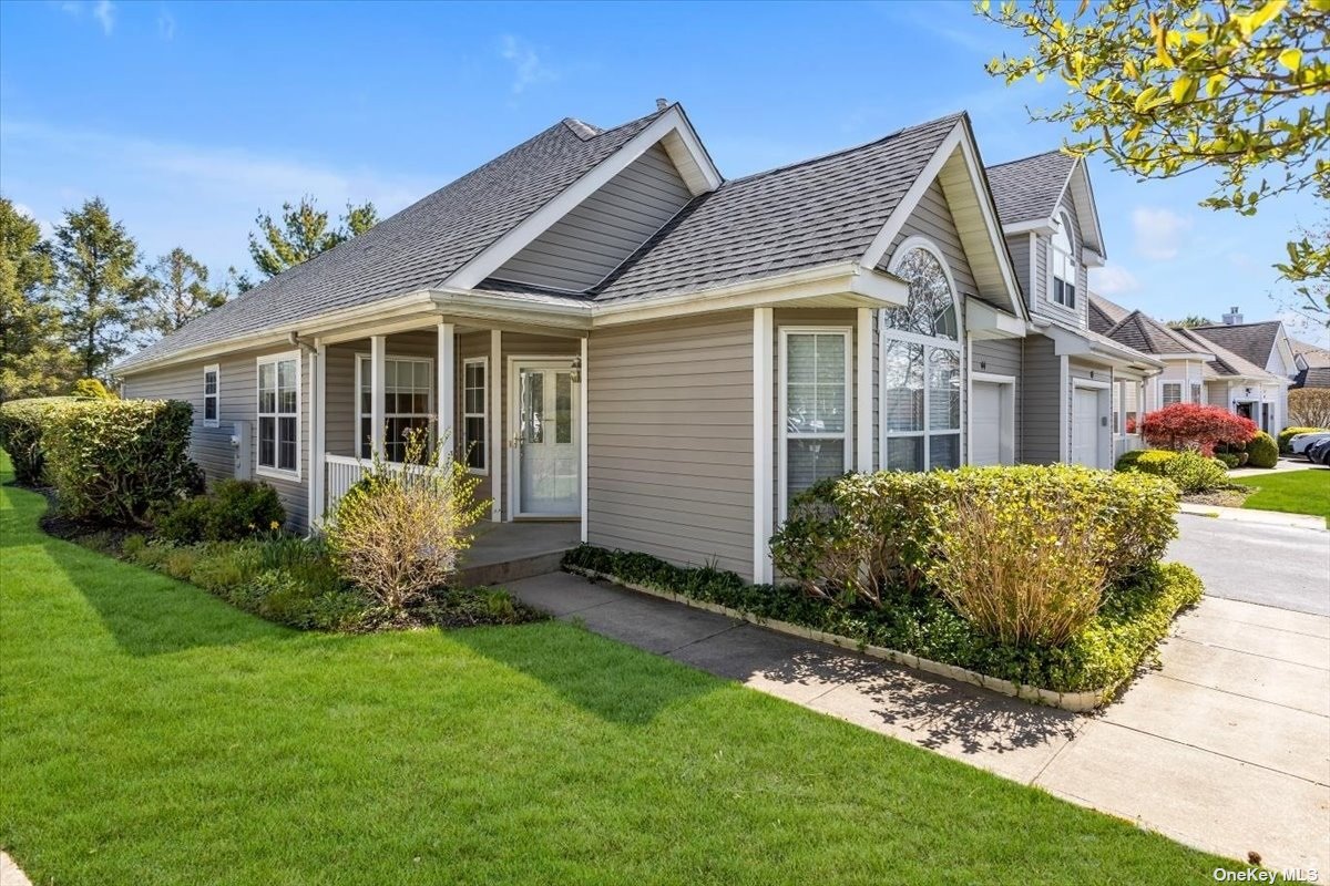 a front view of a house with a garden and plants