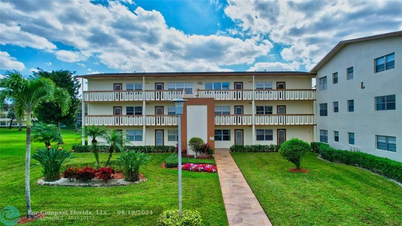 a front view of building with yard