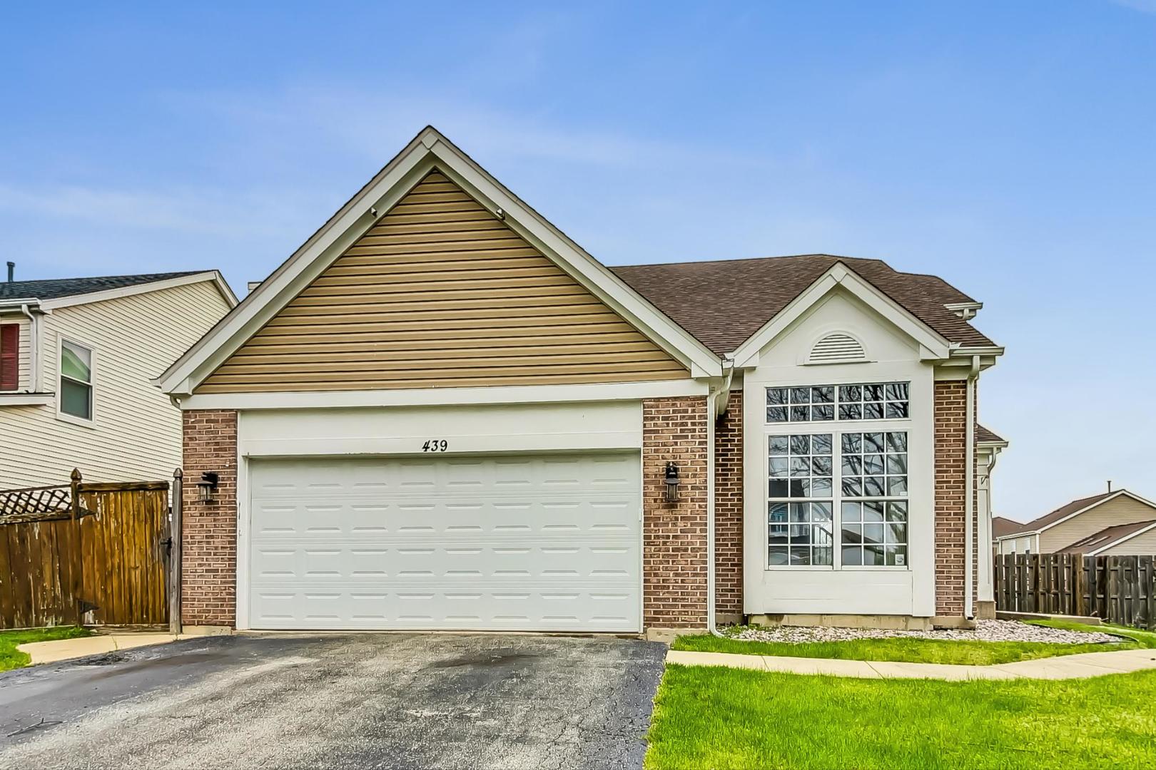 a view of a house with a yard and garage