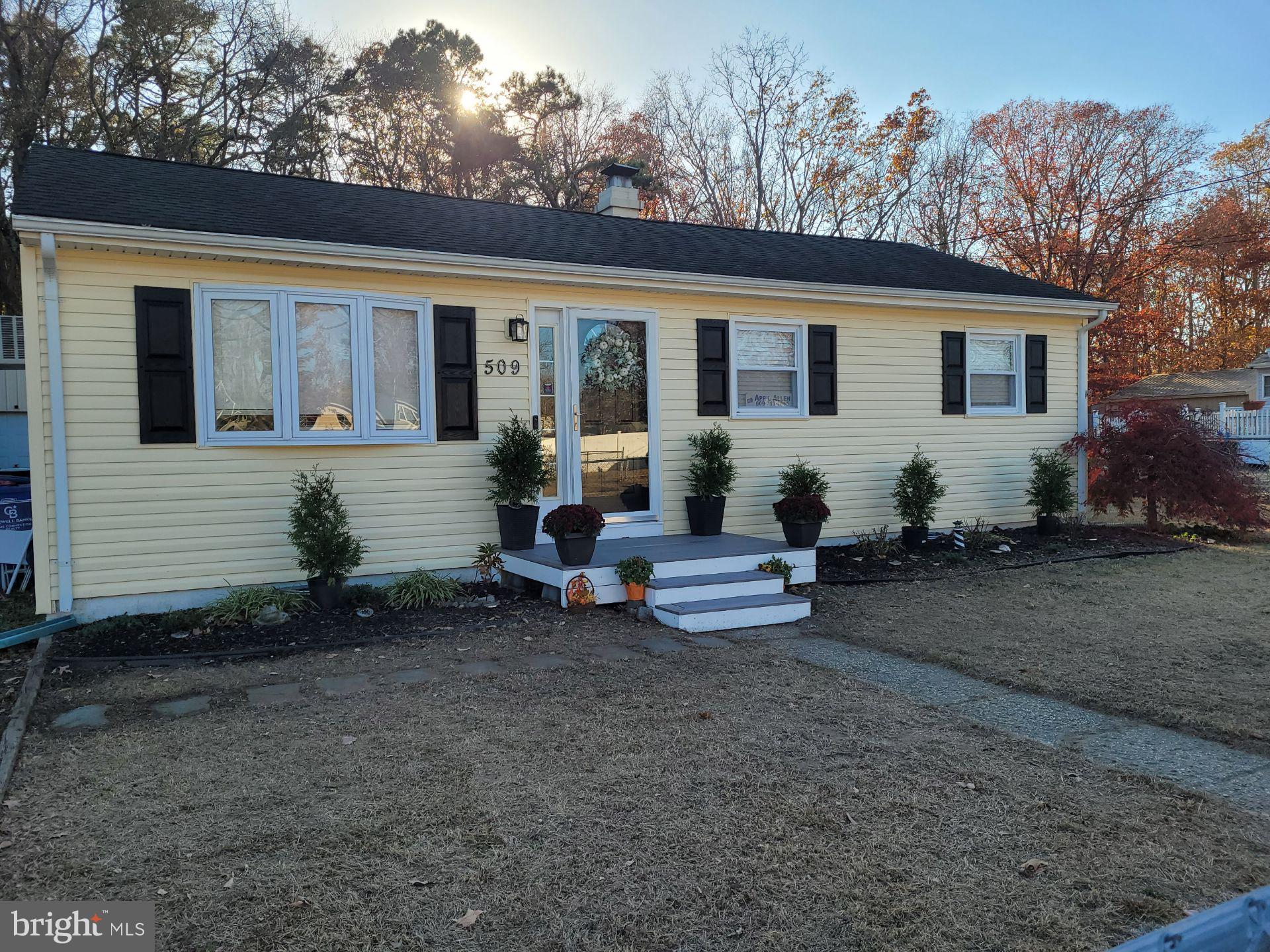 a view of a house with backyard sitting area and garden