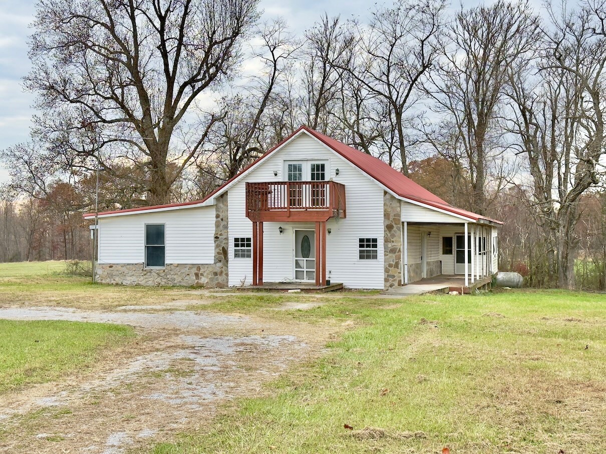 a big house with a big yard and large trees