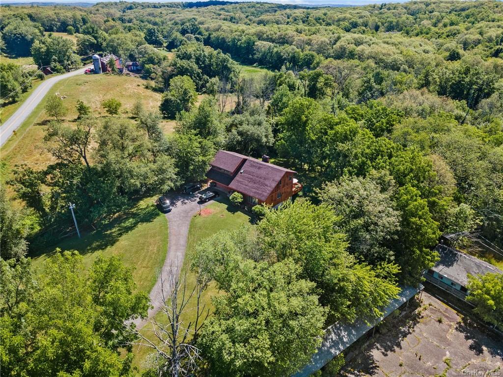 an aerial view of residential house with outdoor space and swimming pool